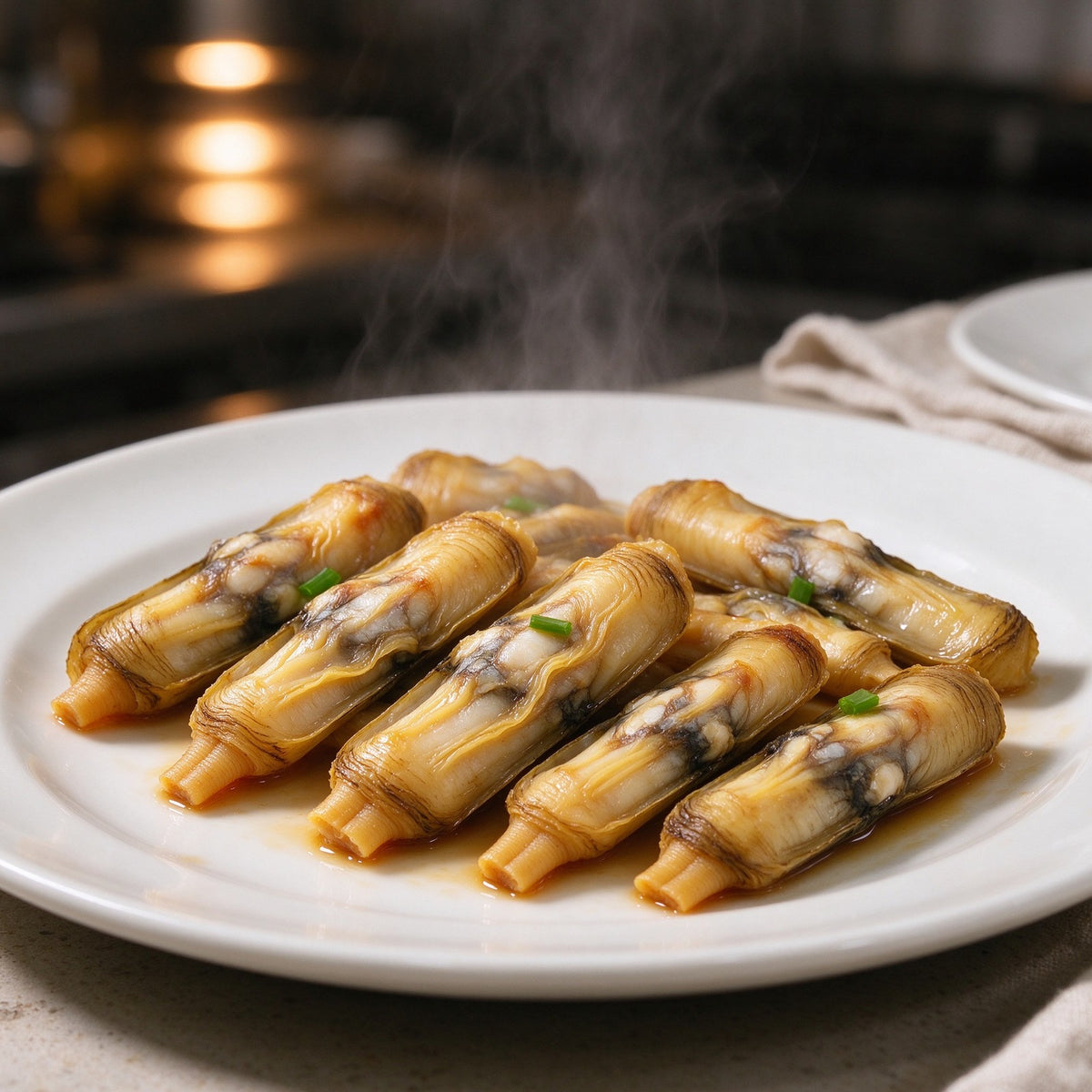 Bamboo clams with ridged olive shells on a metal tray