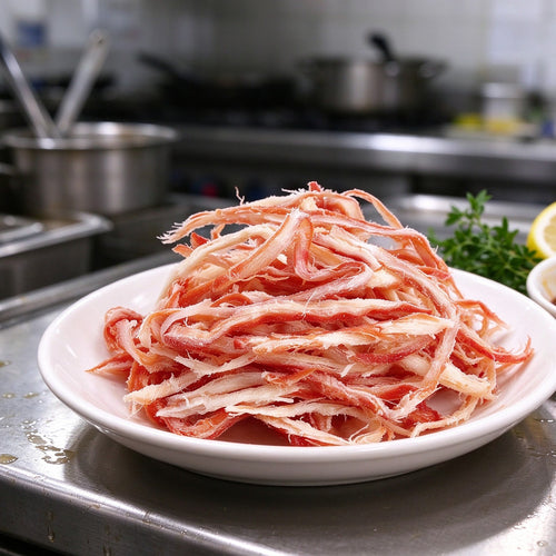 Red and white crab meat strands piled on a plate