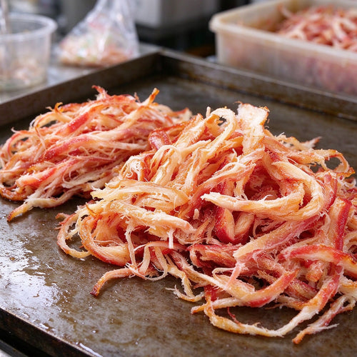 Red and white crab meat strands piled on a plate
