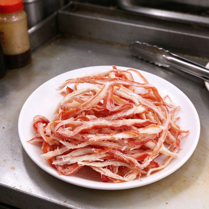 Red and white crab meat strands piled on a plate