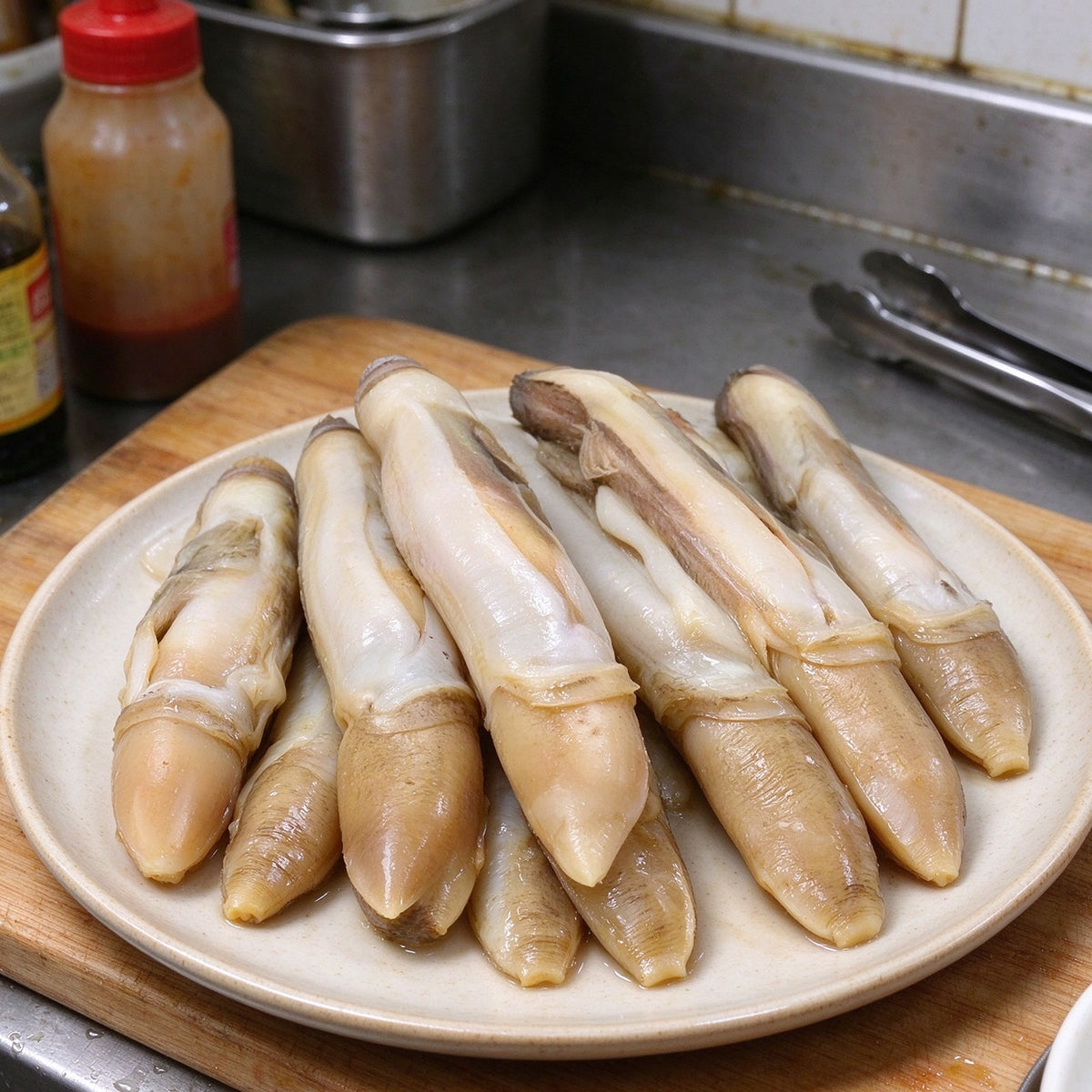 Jumbo razor clams arranged on a serving plate